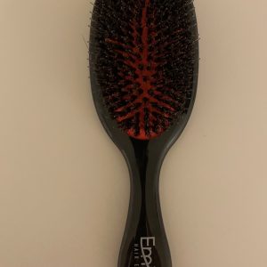 A black and red brush is on the table