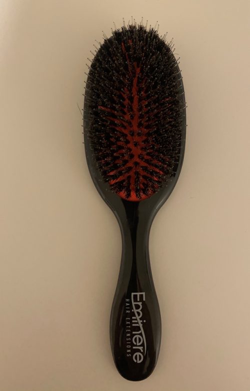 A black and red brush is on the table